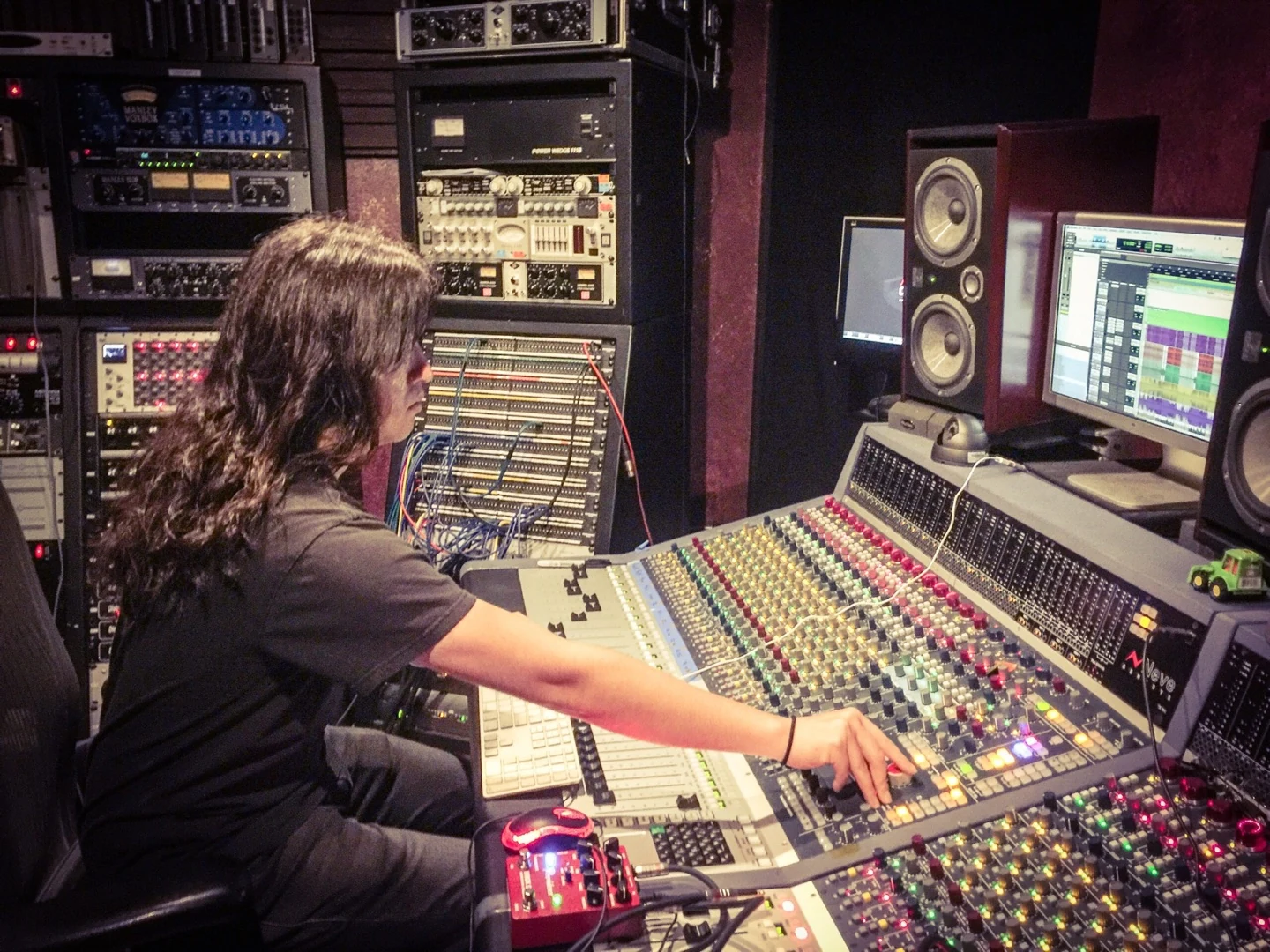 Masaki Murashita working at a recording studio mixing console